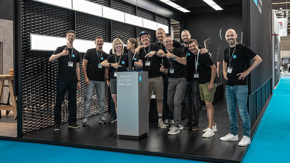 Group photo of the TQ E-Bike Team at an exhibition stand